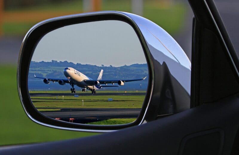 Airplane in mirror of JAX Limo for airport car service tranportation